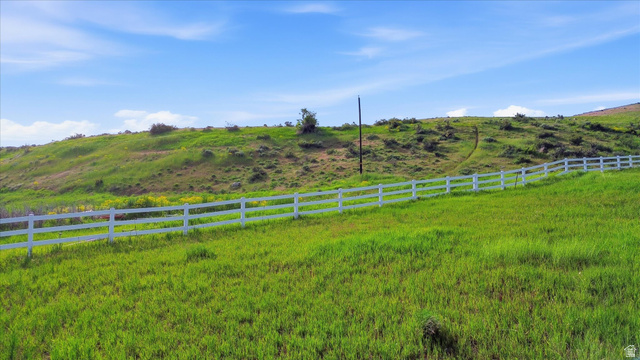 2075 Canyon Road Smithfield, UT 84335 - Photo 16 of 18 Expansive green acreage with a white post-and-rail fence