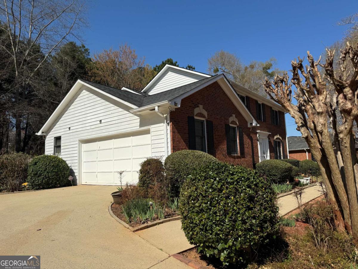 a view of a house with a yard and plants