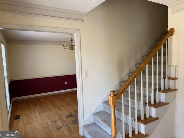 a view of staircase with wooden floor and stairs