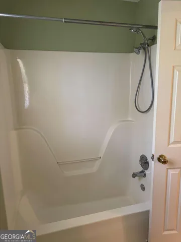 a bathroom with a shower and a shower