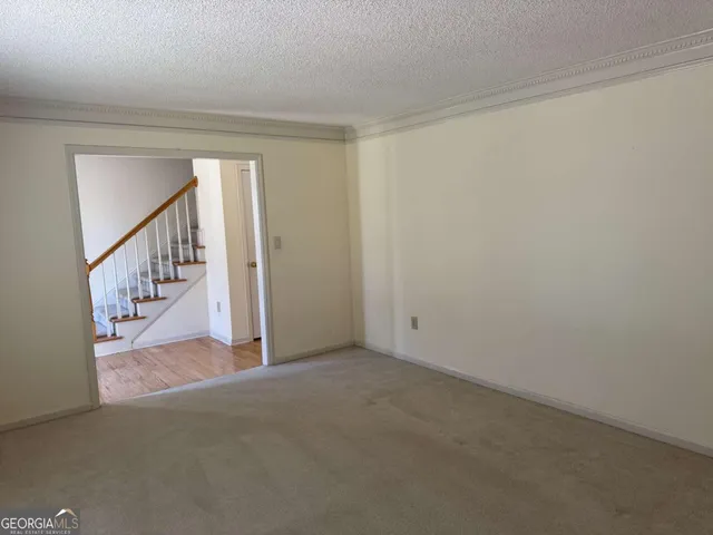 a view of an empty room with stairs