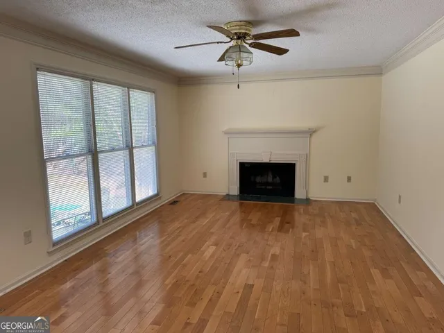 a view of empty room with fan and window