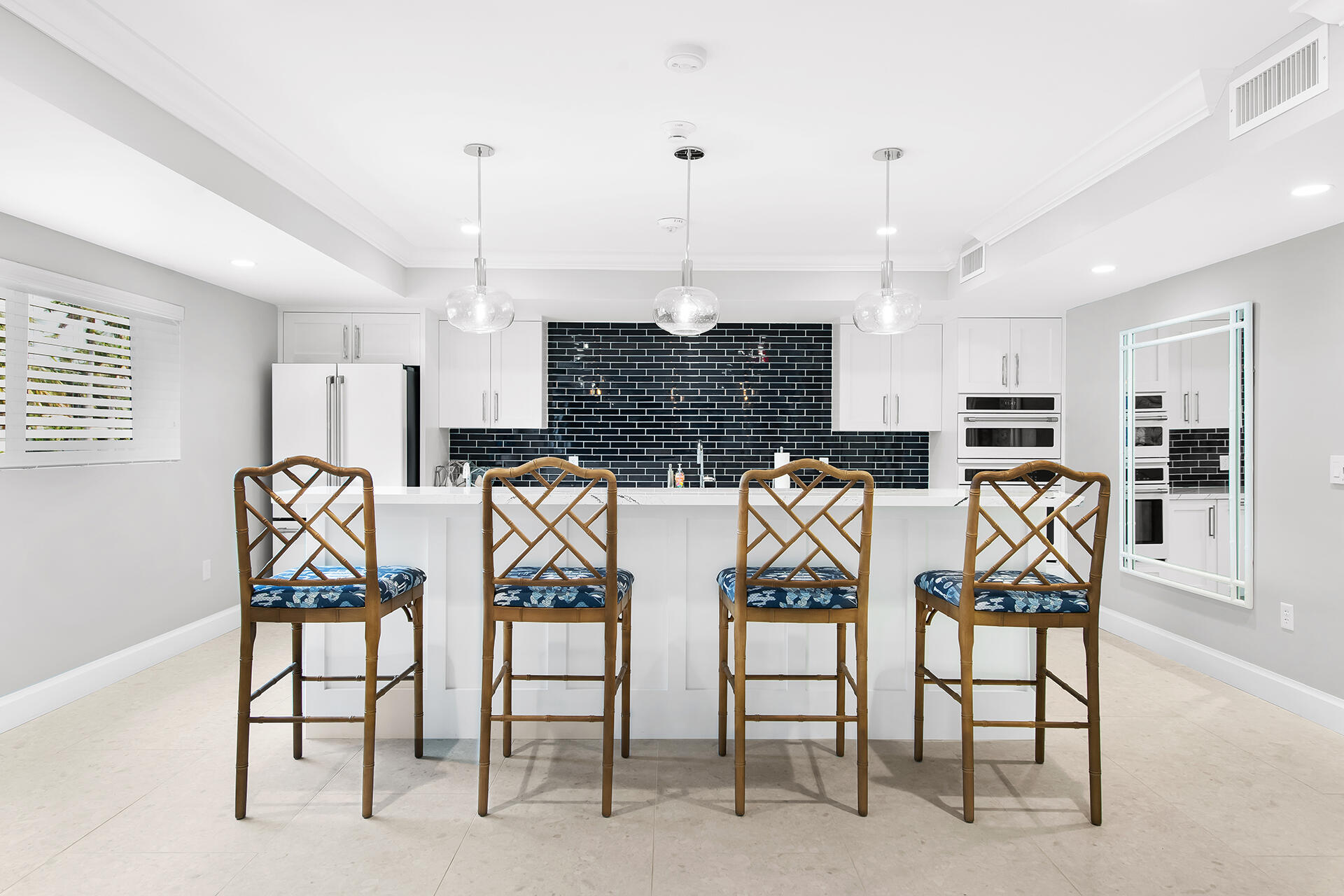 120 North Ocean Boulevard, Unit 202 Delray Beach, FL 33483 - Photo 23 of 32 a kitchen with stainless steel appliances kitchen island granite countertop a table and chairs in it