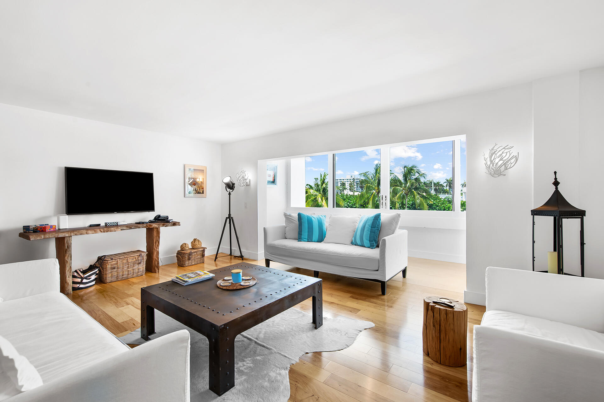 120 North Ocean Boulevard, Unit 202 Delray Beach, FL 33483 - Photo 5 of 32 a living room with furniture and a flat screen tv
