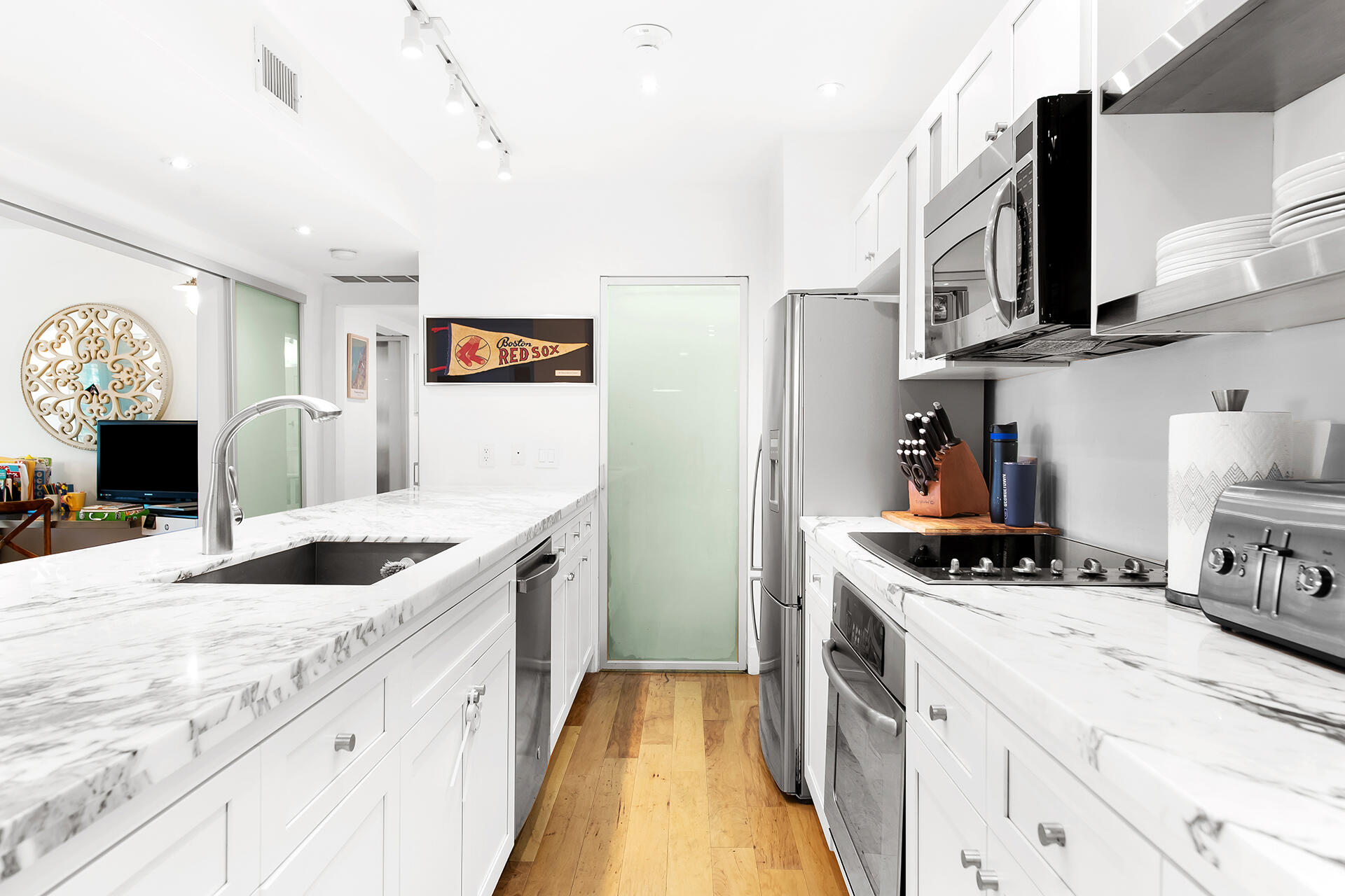 120 North Ocean Boulevard, Unit 202 Delray Beach, FL 33483 - Photo 7 of 32 a kitchen with stainless steel appliances granite countertop a sink and a stove top oven