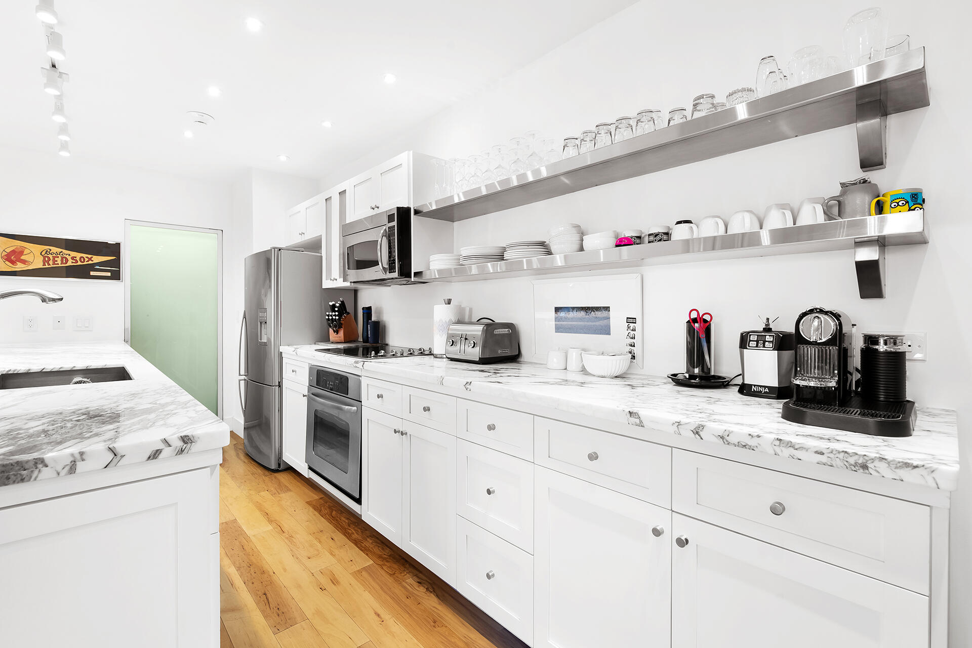 120 North Ocean Boulevard, Unit 202 Delray Beach, FL 33483 - Photo 8 of 32 a kitchen with lots of counter top space and cabinets