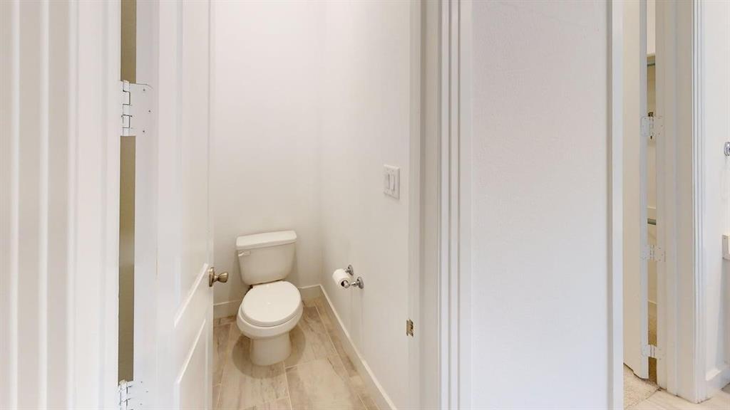 9628 Boulder Pt Road Oak Point, TX 75068 - Photo 21 of 35 Private commode room featuring wood-finish flooring and a chrome toilet paper holder