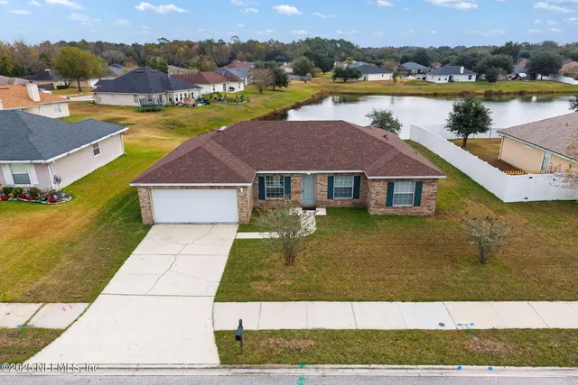 a aerial view of a house with a yard