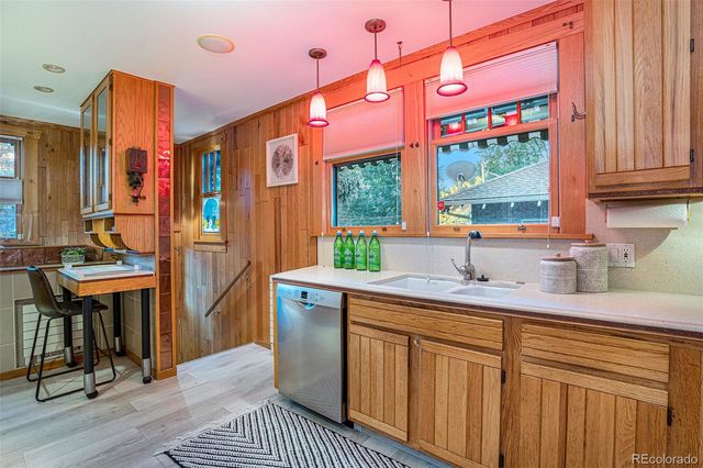 a kitchen with stainless steel appliances granite countertop a sink and a cabinets