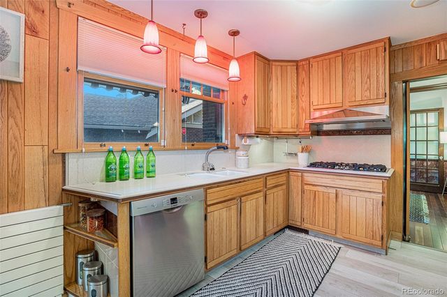 a kitchen with a sink window and cabinets