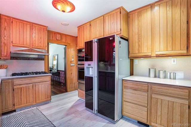 a kitchen with stainless steel appliances granite countertop a refrigerator sink and cabinets