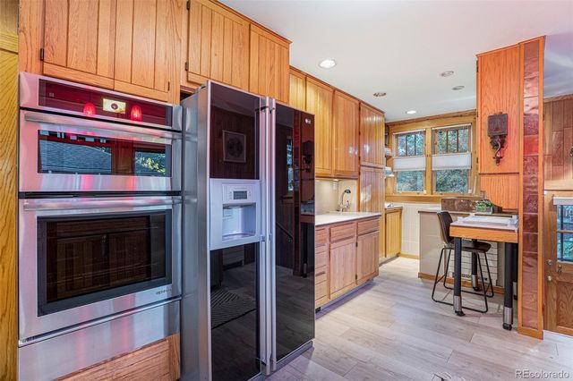 a kitchen with stainless steel appliances granite countertop a refrigerator and cabinets