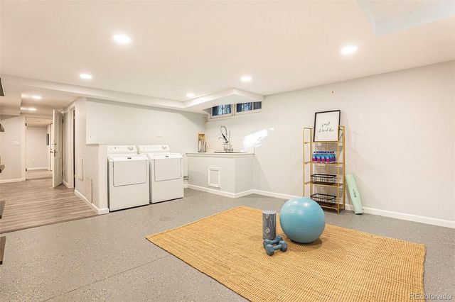 a kitchen with stainless steel appliances kitchen island sink refrigerator and cabinets