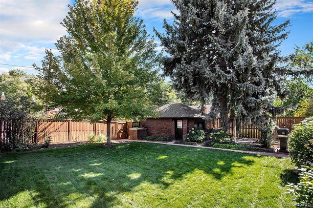 a view of a table and chairs under an umbrella