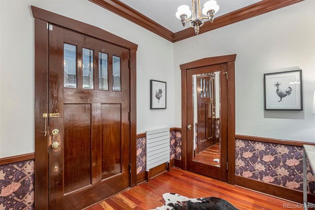 a view of a hallway with wooden floor and stairs