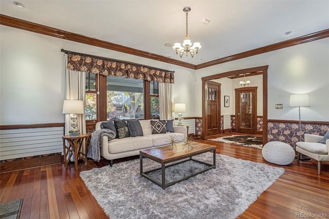 a living room with furniture and a chandelier