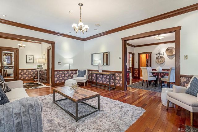 a living room with furniture and a chandelier