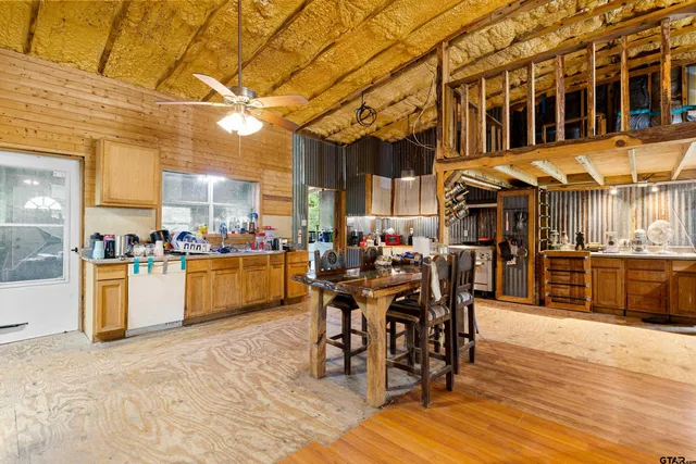 a outdoor space with lots of chairs a sink a dining table and chairs