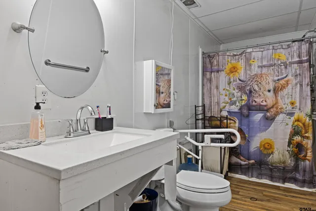 a bedroom with a bed and a dresser next to a window