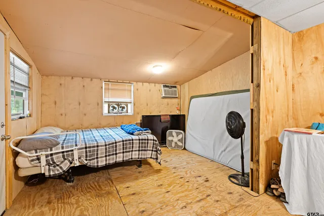 a bedroom with furniture and a window