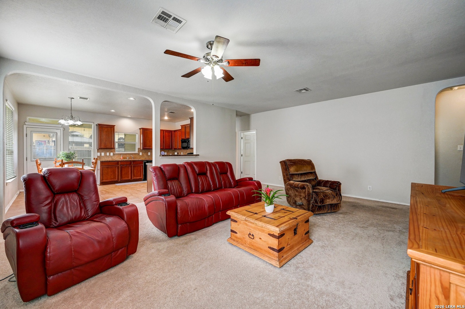 720 Hollow Ridge Schertz, TX 78108 - Photo 8 of 27 a living room with furniture a ceiling fan and a rug