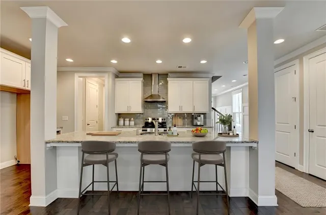 a large kitchen with granite countertop a stove top oven a sink and a fireplace