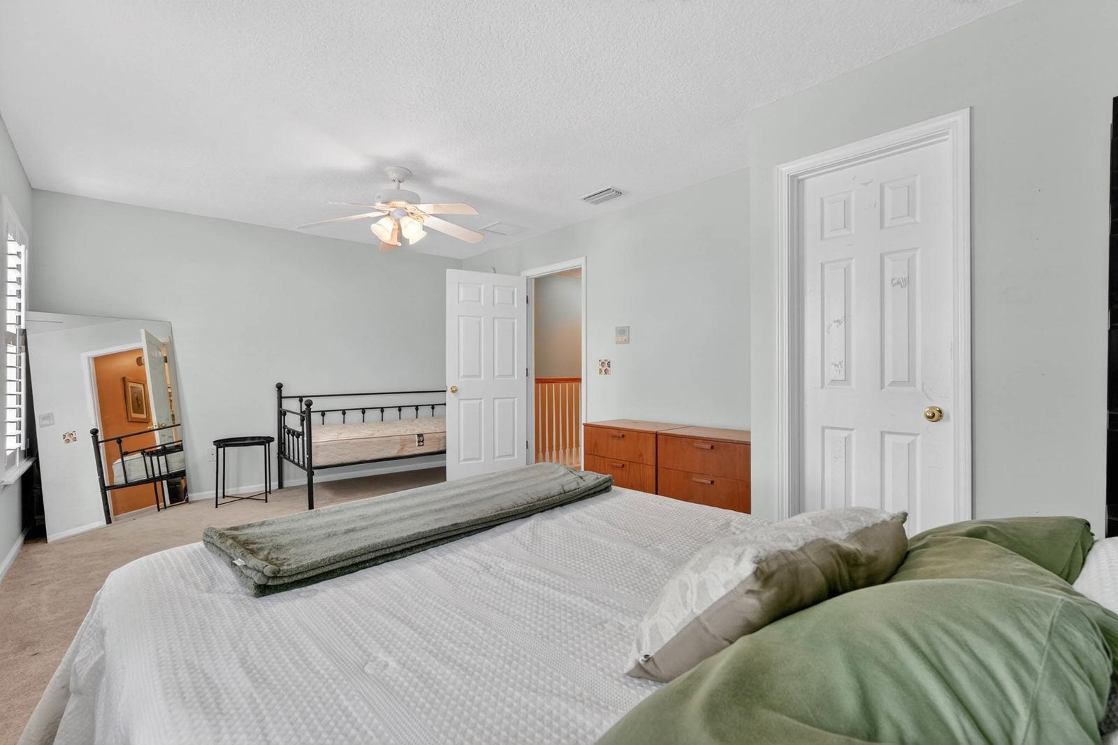 1237 Splendid Ravine Street St. Augustine, FL 32092 - Photo 22 of 62 a bedroom with a large bed and a chandelier