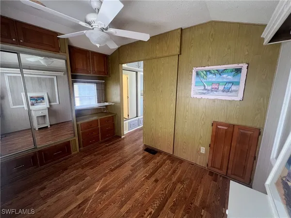 a open kitchen with cabinets and wooden floor