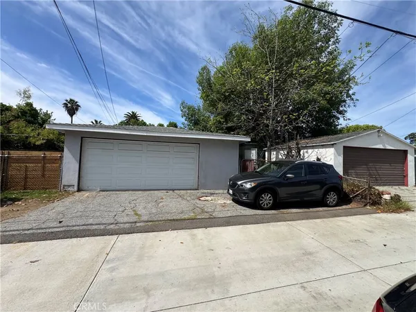 a view of a car parked in front of a house