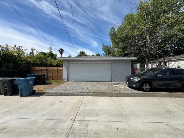 a view of a house with a yard and garage