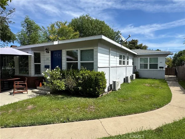 a view of a house with a yard patio and a garden