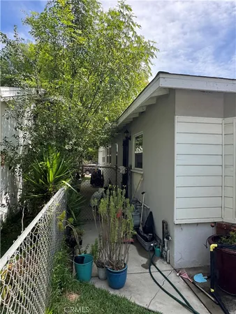 a view of backyard with outdoor seating and plants