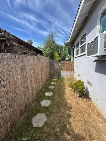 a view of a backyard with chair and tables
