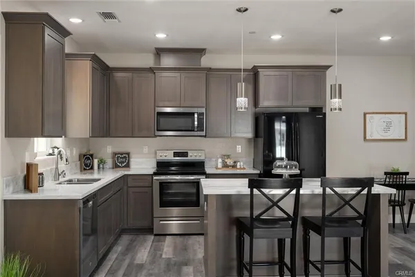 a kitchen with a sink stainless steel appliances and cabinets