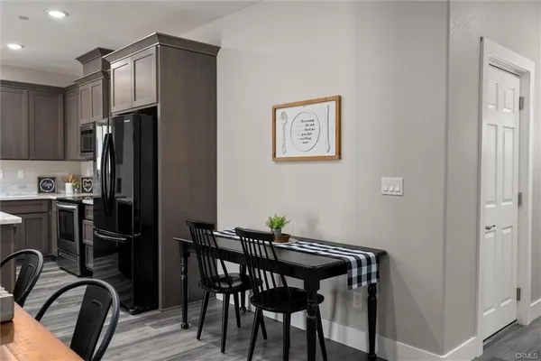 a kitchen with stainless steel appliances granite countertop a refrigerator and a stove top oven