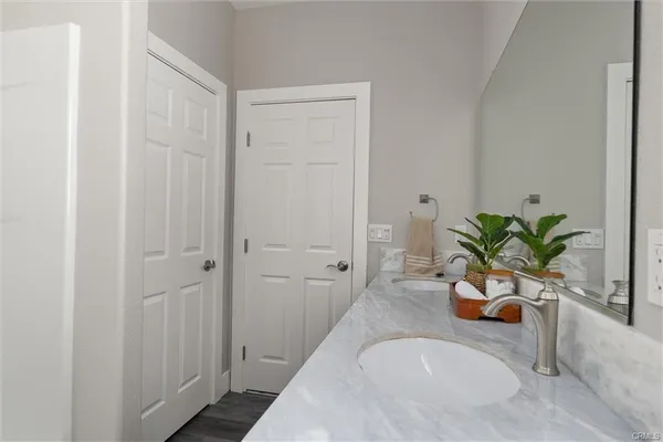 a bathroom with a tub a sink and mirror