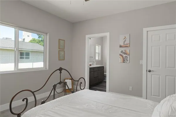 a bedroom with a bed and a large window