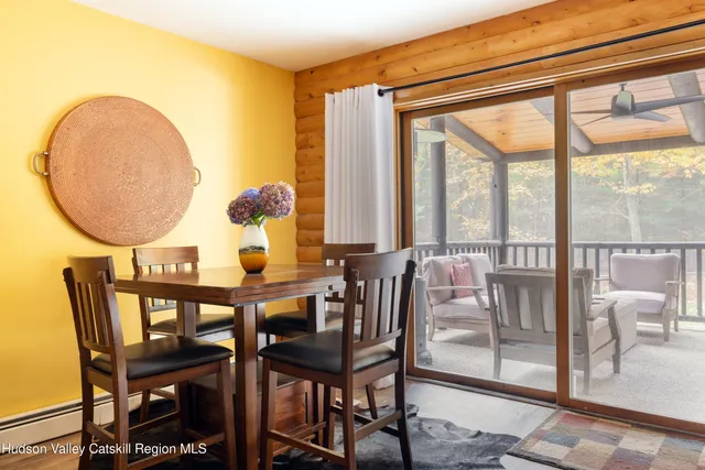 a view of a dining room with furniture and a window