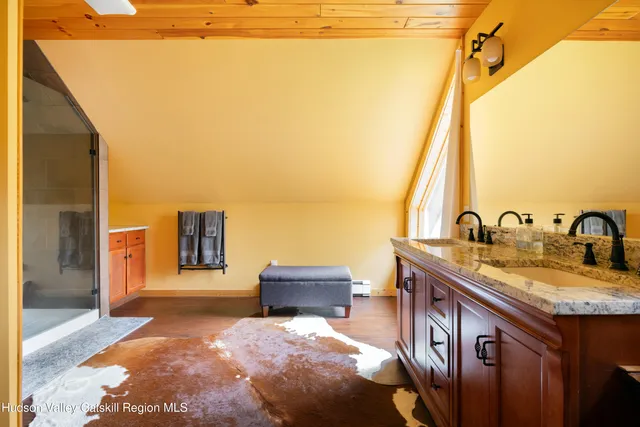 a spacious bathroom with a granite countertop sink and a mirror