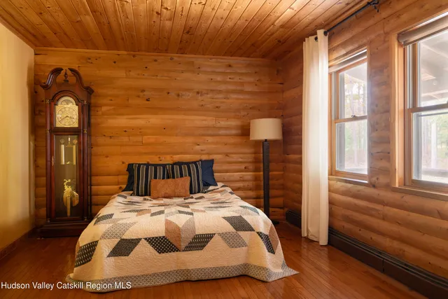 a bed sitting in a bedroom next to a window