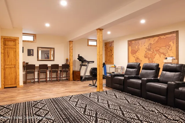 a living room with furniture a large window and closet