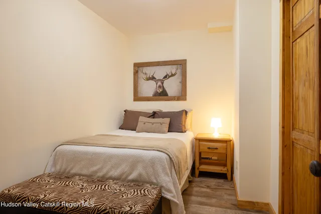 a bedroom with a bed and a painting on the wall