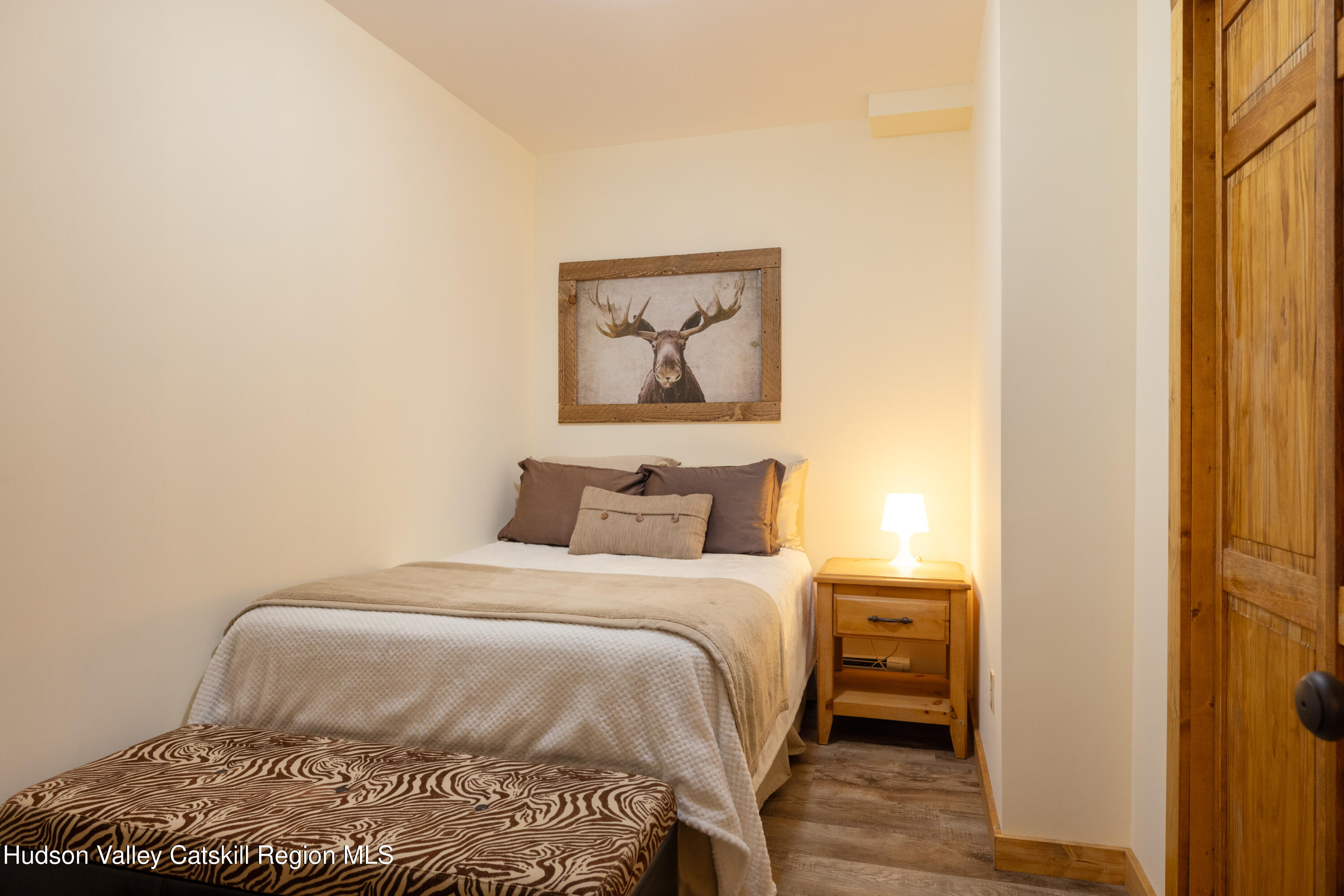 231 Decker Road Sparrowbush, NY 12780 - Photo 21 of 31 a bedroom with a bed and a painting on the wall