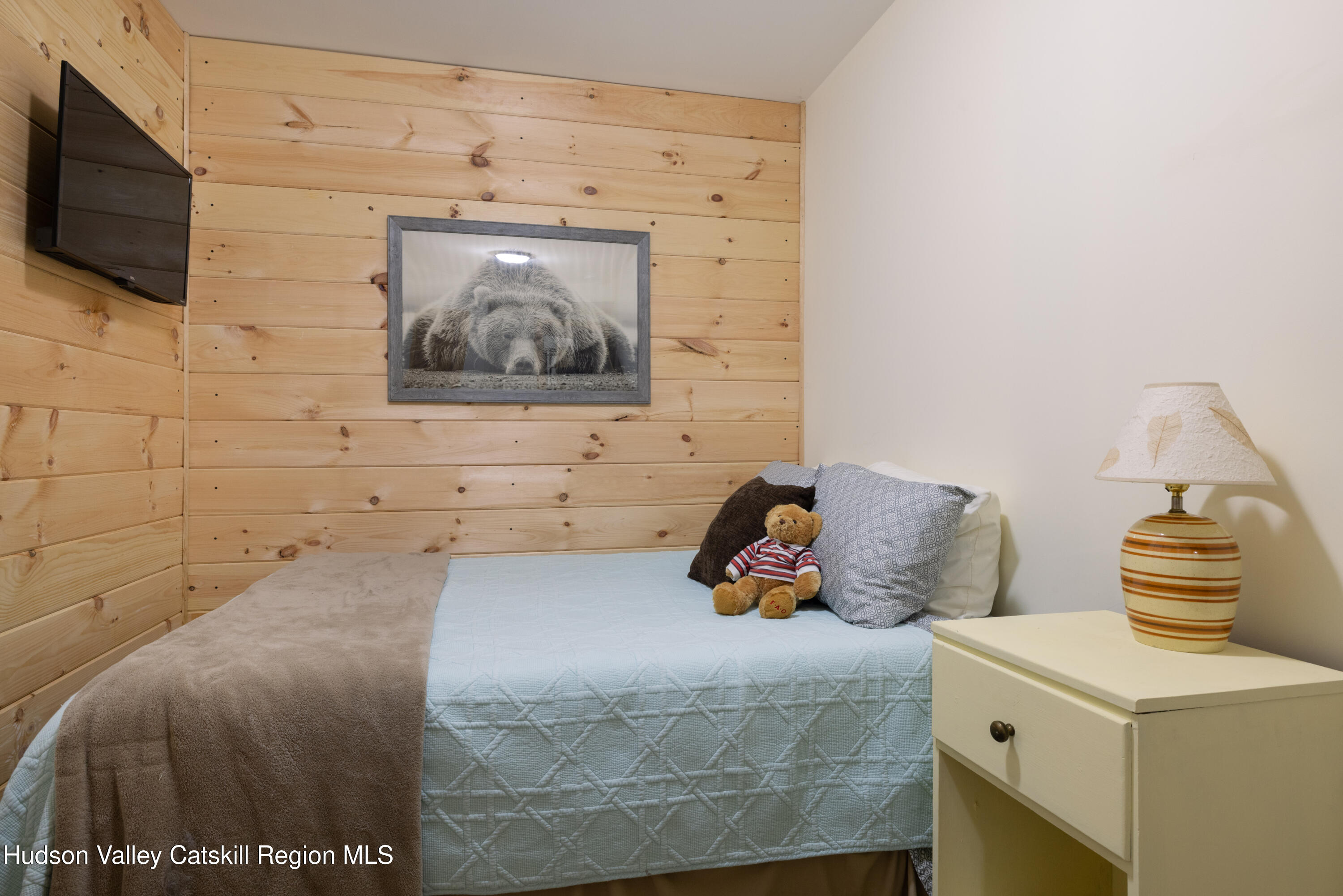 231 Decker Road Sparrowbush, NY 12780 - Photo 23 of 31 a bed room with a bed and a television