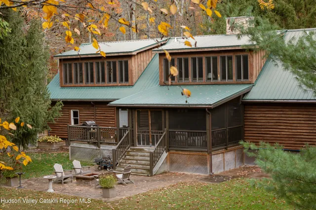 a view of a house with backyard porch and sitting area