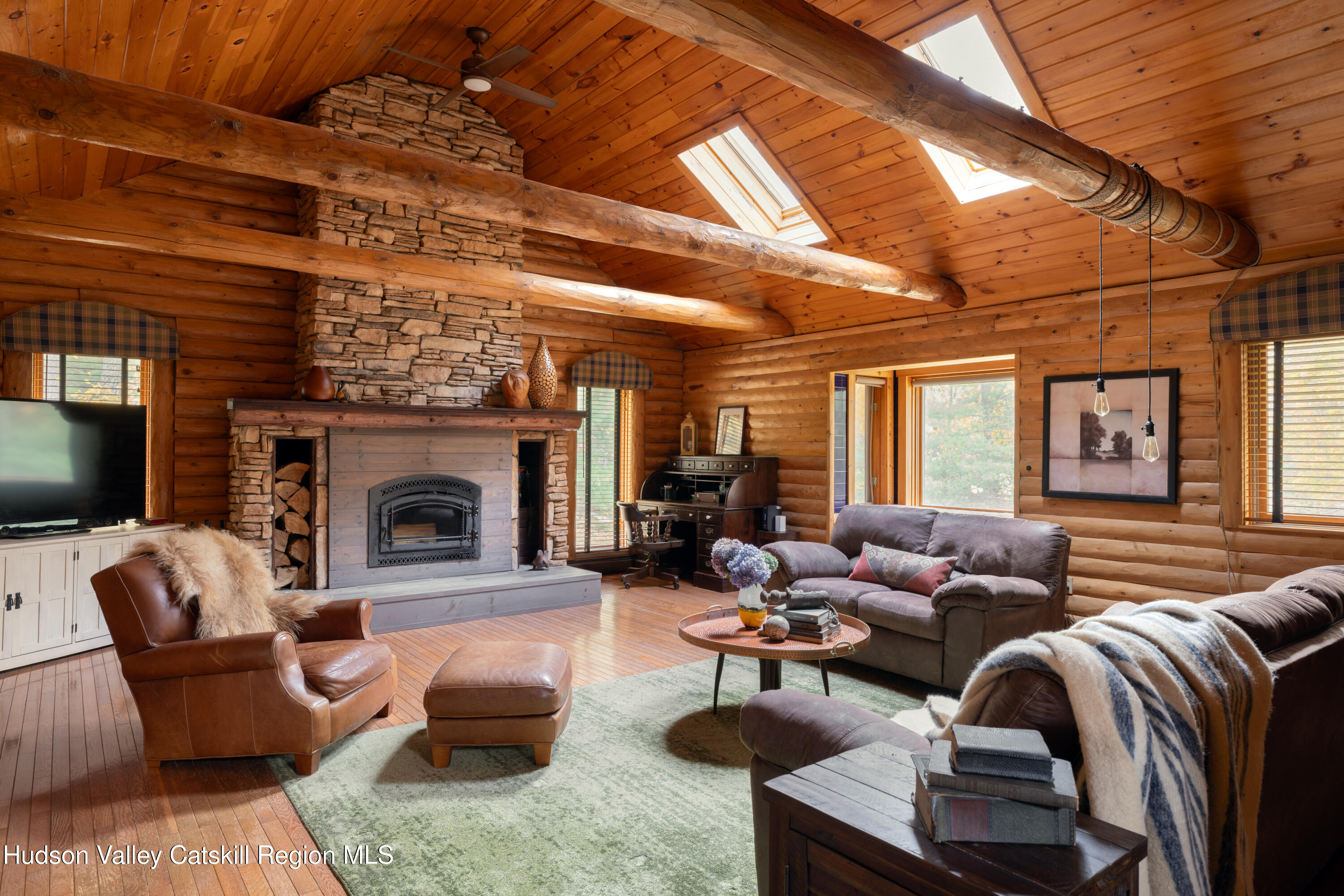 231 Decker Road Sparrowbush, NY 12780 - Photo 7 of 31 a living room with furniture a fireplace and a flat screen tv