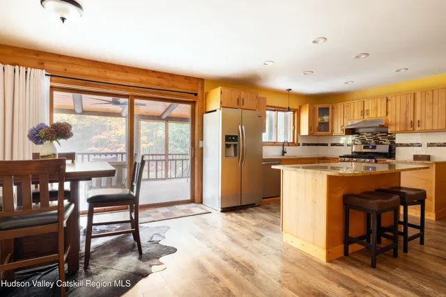 a kitchen with a table chairs refrigerator and cabinets