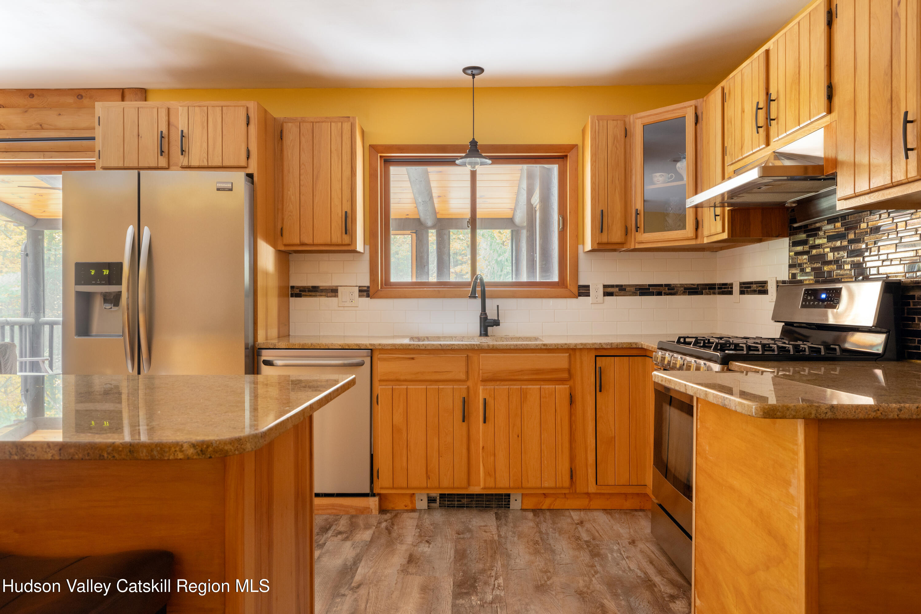 231 Decker Road Sparrowbush, NY 12780 - Photo 9 of 31 a kitchen with stainless steel appliances granite countertop a refrigerator a sink dishwasher a stove with wooden cabinets and floor