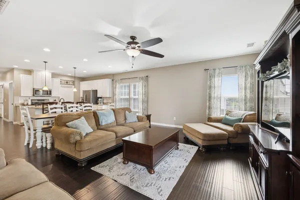 a living room with furniture and a chandelier