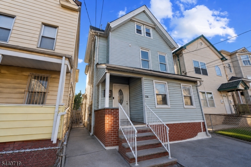 136 Smith Street Elizabeth, NJ 07201 - Photo 3 of 38 a front view of a house with stairs